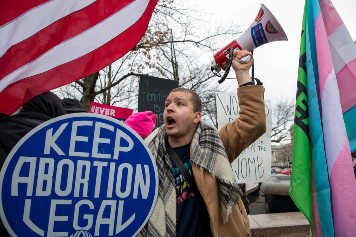 An abortion rights demonstrator tries to block an anti-abortion group at the Women's March, which largely focused on abortion rights, at Freedom Plaza in Washington, Sunday, Jan. 22, 2023. (AP Photo/Amanda Andrade-Rhoades)